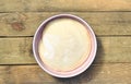 Dough in a pink bowl on rustic rough wooden table