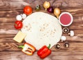 Dough for pizza with raw pizzas ingredients on the wooden background. Top view Royalty Free Stock Photo