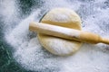 Dough on a floured marble green table, top view