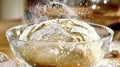 Dough rises in glass bowl showing bubbles and cracks during Royalty Free Stock Photo