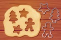Dough with rolling pin cookie cutter star, man, christmas tree shapes shape top view cartoon style on wooden table