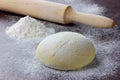 Dough with rolling pin and flour Royalty Free Stock Photo