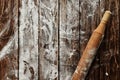Dough rolling pin with flour on wooden table Royalty Free Stock Photo
