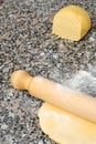 Homemade cake, dough and rolling pin on marble background, verti