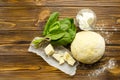 Dough, spinach,parmesan, ricotta on wooden background are ready