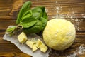 Dough, spinach,parmesan on wooden background are ready for cooking pasta.