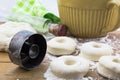 Doughnut dough on floured oak wood table with vintage cutter and