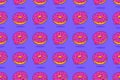 Doughnut seamless pattern. Donuts with pink icing Royalty Free Stock Photo
