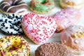 Doughnuts donuts various types of cakes with heart fat thursday Valentine`s Day concept