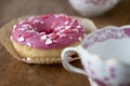 Pink donut with sugar icing and coffee cups Meissen china Royalty Free Stock Photo