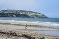 Douglas, Isle of Man, June,16, 2019.Man running at the beach with cruise ship close to shore. Powerful runner training outdoor on Royalty Free Stock Photo