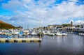 DOUGLAS, ISLE OF MAN - OCTOBER 17: Yacht docking at bay in a nice small port in a clear blue sky day in a small town of Doug
