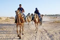 Arab Men Riding Camels in Desert near Douz, Tunisia