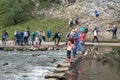 Tourists crossing  the famous stepping stones at Dove Dale`s stepping stones Royalty Free Stock Photo