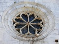 Dove resting on rose window of romanic church valdicastello Royalty Free Stock Photo