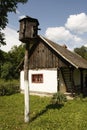 Dovecot, pigeonry and rustic village house with white walls and wooden roof.