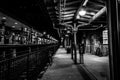 Dover, NJ USA - November 1, 2017: Bicycles rest along the grungy train station at night, black and white Royalty Free Stock Photo