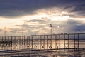 Doves sitting on a pier at dawn on cloudy morning Royalty Free Stock Photo