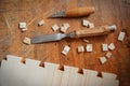 Handmade dovetail joints in furniture workshop. Chisel and saw on table. Royalty Free Stock Photo