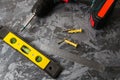 Dowel screwdriver and level on concrete. Concept advertising construction companies Royalty Free Stock Photo
