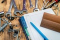 dowel screws and keys are scattered on the table next to a folder and a pen. Royalty Free Stock Photo