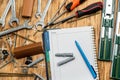 dowel screws and keys are scattered on the table next to a folder and a pen. Royalty Free Stock Photo