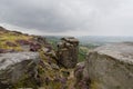 Down among the gritstone rocks of Curbar Edge high in the Peak District on a damp, misty summer day