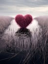 Down heart in the middle of a ditch around dry grass. Heart as a symbol of affection and