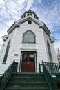 Down low perspective of church front with blue sky and clouds