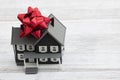 Down payment gift with a house with a bow on a desk Royalty Free Stock Photo