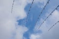 Down rigging fishing rods against blue sky. Trolling equipment on boat. Focus on tops of rods