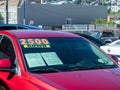 2500 down sign on red car on used car dealership