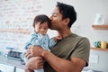 Down syndrome baby bonding with father in their home, kiss and affection by caring parent for special needs infant. Love Royalty Free Stock Photo