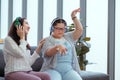 Down syndrome girl is listening to music and singing with her mother holiday home