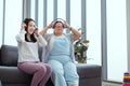 Down syndrome girl is listening to music and singing with her mother holiday home