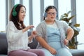 Down syndrome girl is listening to music and singing with her mother holiday home