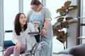 Down syndrome girl talking to mom in a wheelchair in the house