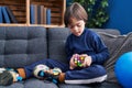 Down syndrome kid playing with puzzle cube at home Royalty Free Stock Photo