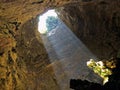 Down view of earth hole and light in cave Castellana Grotte Puglia