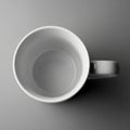 Down view of a plain white ceramic mug resting on a smooth gray Royalty Free Stock Photo