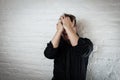 Downcast man holds his head as he suffers from depression and failure. Use it for a headache, money trouble or domestic violence Royalty Free Stock Photo