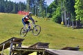 Downhill bike rider jumping off ground at mountain bike race Royalty Free Stock Photo