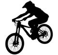 Downhill mountain bike, enduro cross mountain biker doing an extreme jump on a mountain bike. with helmet and safety equipment sil