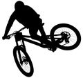 Downhill mountain bike, enduro cross mountain biker doing an extreme jump on a mountain bike. with helmet and safety equipment sil