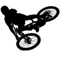Downhill mountain bike, enduro cross mountain biker doing an extreme jump on a mountain bike. with helmet and safety equipment sil
