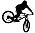 Downhill mountain bike, enduro cross mountain biker doing an extreme jump on a mountain bike. with helmet and safety equipment sil