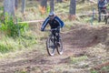 Downhill rider with bicycle. Fast speed and jump. Autumn 2018.