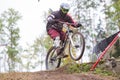 Downhill rider with bicycle. Fast speed and jump. Autumn 2018.