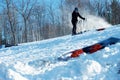 Downhill Skier Holding Poles while Releasing Boots