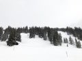 Downhill slope and apres ski and beautiful view of the Alps mountains Royalty Free Stock Photo